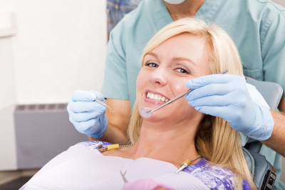 A smiling woman at the dentist ready for a check-up